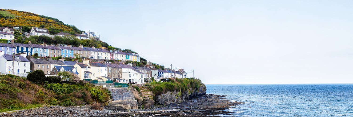 Coloured houses overlooking the ocean in New Quay, Wales