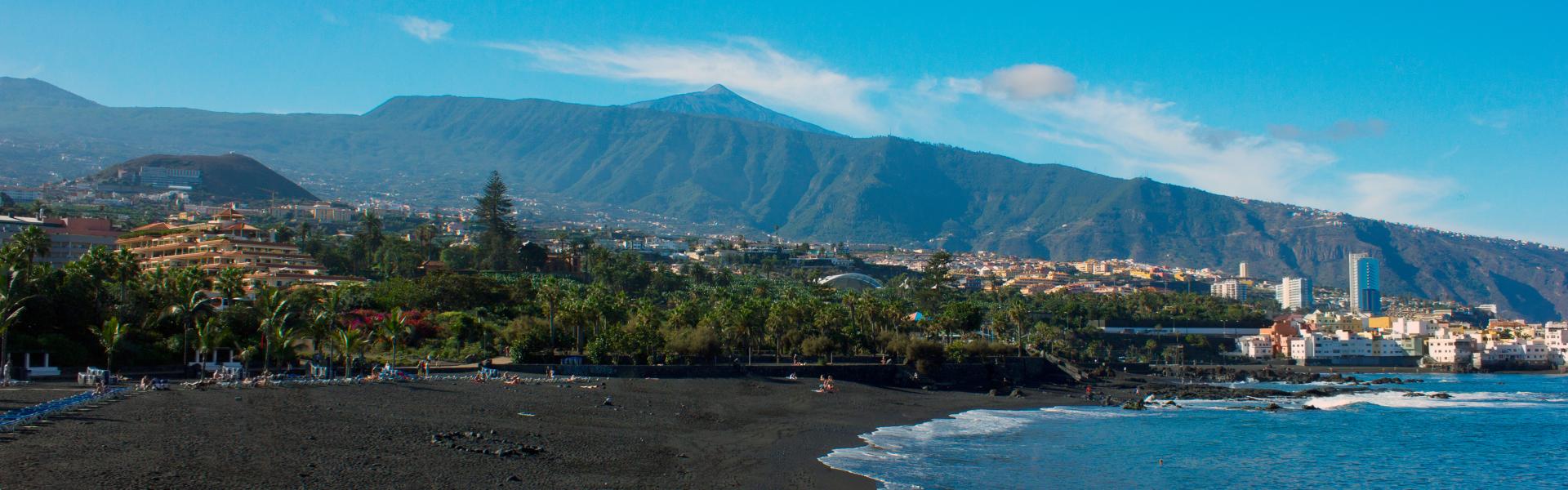 Beach view with black sand and blue ocean