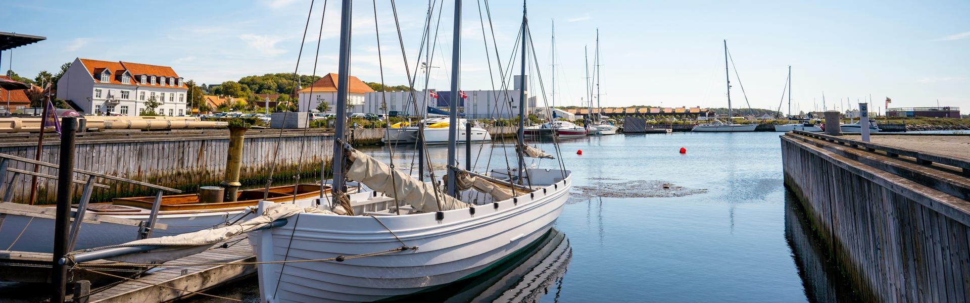 white boat on body of water during daytime