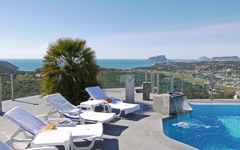 Deckchairs on a terrace overlooking the ocean