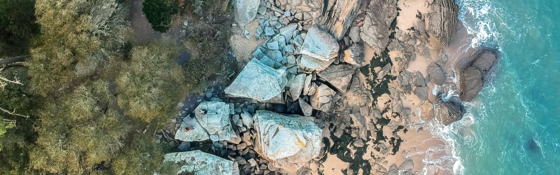 aerial view photography of rocks near body of water during daytime