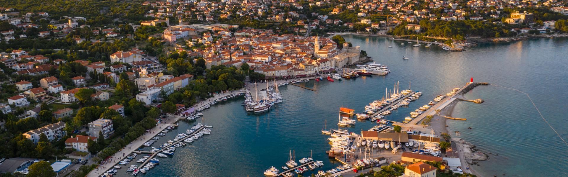 Sunset over the medieval Krk old town and harbor in the Krk island in Croatia