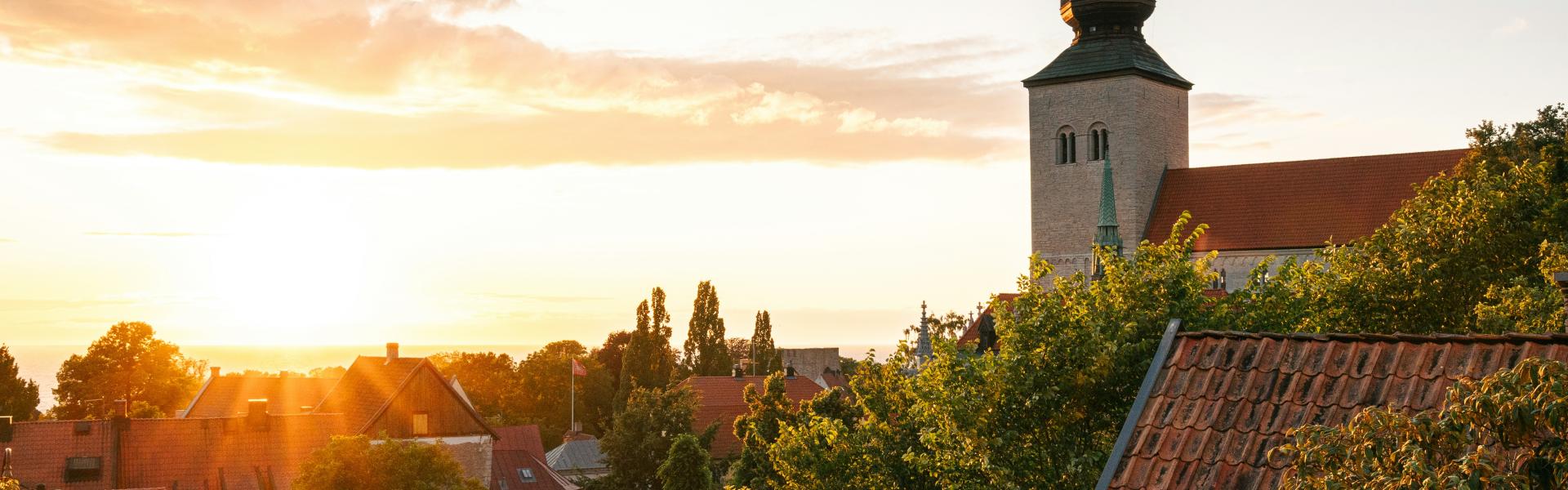 the sun is setting over a small town