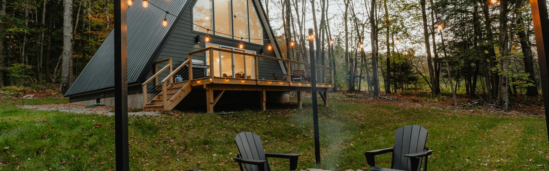 a small cabin with a fire pit in the yard