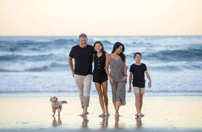 Family with dog on a beach
