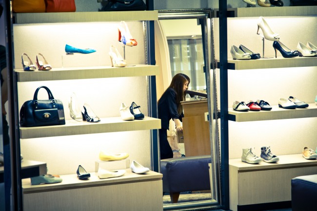 A woman looking at shoes in a shop