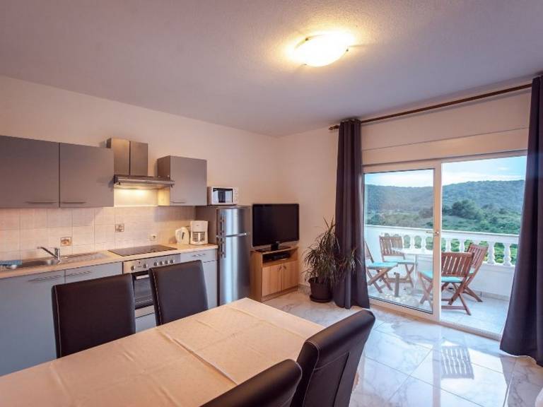 Apartment with barbecue, yard & patio in Rab