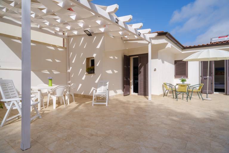 Vacation home with terrace, yard & BBQ | Garden view in Porto Cesareo