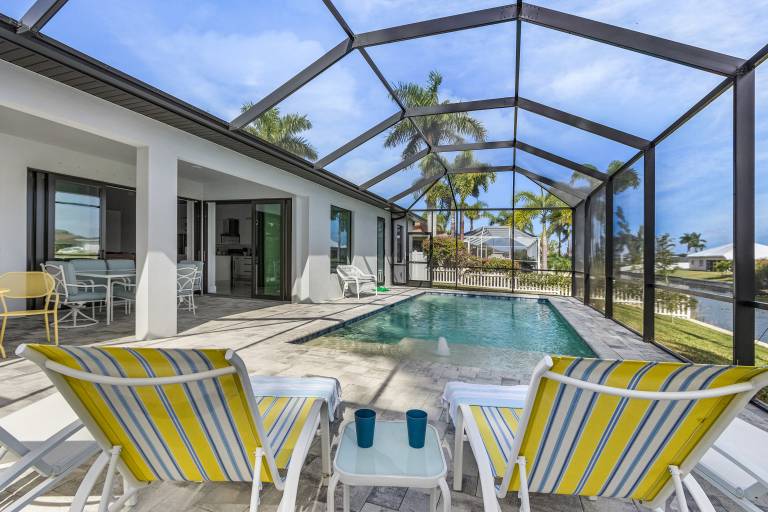 Pool overlooking canal, Outdoor Grilling station - Villa Sand Dollar Siesta in Cape Coral, FL
