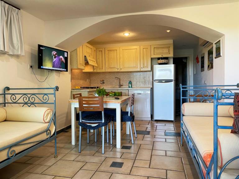 EUC 143_Apartment surrounded by greenery, with patio, outdoor dining area and swimming pool. in Golfo Aranci