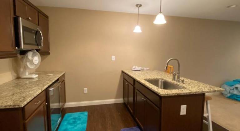 Private basement bedroom with private bathroom, kitchen, and living room with large screen televisio — photo 4